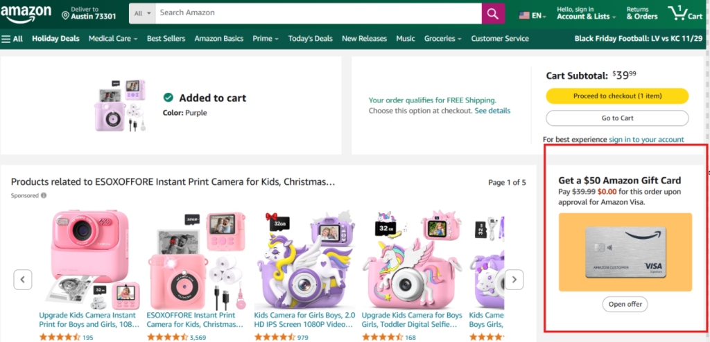 Screenshot of an Amazon online shopping checkout page, highlighting a purple instant print camera for kids added to the cart, with a promotion for an Amazon Visa gift card and related camera products displayed.